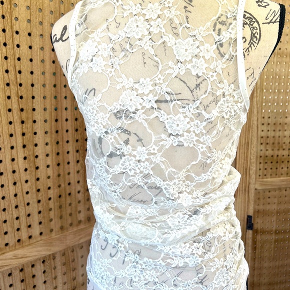 Cream color sleeveless top.Has Gold color Dots and a lace see through back. - Picture 6 of 8